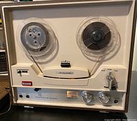 Front view showing reels, controls, and labeling on the tape player