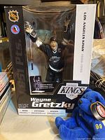 Wayne Gretzky McFarlane figure in original packaging showing the figure inside along with NHL logos and Kings branding