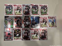 Image showing 15 NFL trading cards featuring Atlanta Falcons players in various action poses.