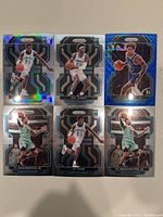 Photo of six Charlotte Hornets NBA basketball cards featuring players PJ Washington Jr., Kai Jones, Kelly Oubre Jr., and JT Thor with Prizm holographic design.