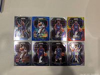 Photo showing eight Detroit Pistons NBA basketball cards in holographic Panini Prizm design.