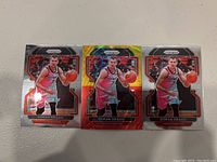 Three Panini Prizm basketball cards of Goran Dragic in Toronto Raptors uniform, including one parallel holographic card and two standard cards.