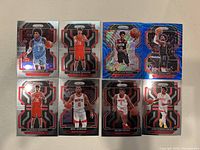 Photo showing 8 Houston Rockets NBA basketball trading cards with various players, mostly Panini Prizm design cards with holographic or refractor foil effects.
