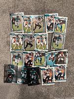Photo of 18 NFL Jacksonville Jaguars trading cards featuring mostly quarterback Trevor Lawrence in multiple action poses, foil and refractor finishes.