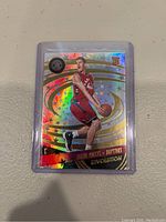 Front view of Jakob Poeltl rookie Revolution basketball card showing holographic finish with Toronto Raptors uniform and RC marking.