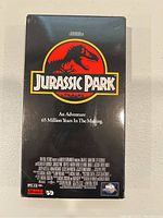 Front cover of Jurassic Park VHS tape showing logo and tagline