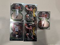Five Milwaukee Bucks NBA player cards laid out on white surface, featuring Khris Middleton, Brook Lopez, and Giannis Antetokounmpo.