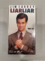 Front cover of sealed Liar Liar VHS tape showing Jim Carrey and title.