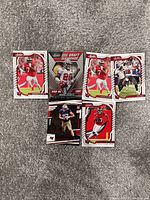 Six Tampa Bay Buccaneers NFL trading cards on a gray carpet background