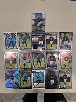 Photo of fifteen Tennessee Titans NFL trading cards arranged in a grid layout, showing various players in different poses and card designs.