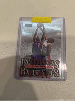 Photo of basketball trading card featuring Theo Ratliff in an Atlanta Hawks uniform mid-play depicting a block or rebound.