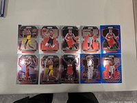 Ten basketball trading cards on a table, each featuring a Washington Wizards player in various poses and card colors including silver, orange, and blue.