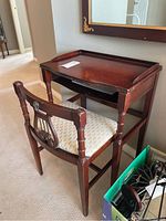 Photo of vintage telephone table and lyre back chair positioned near a wall and mirror, showing side and front views.