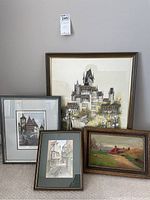 Group photo of all five framed prints on the floor against a wall showing variety of scenes and frame styles.