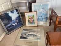 Image showing all four framed prints together, including the Toni Onley 'Whistler' print, colorful tropical scene, blue-toned architectural horse print, and nighttime water reflection print.