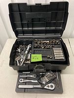 Open Craftsman toolbox showing organized ratchets, sockets, and extensions inside trays.