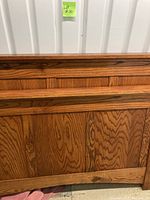 Close-up photo of wood headboard with horizontal trim and wood grain texture