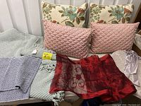 Photo showing all pillows, the Pottery Barn throw, blue placemats, and maroon table runner arranged on a surface