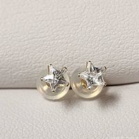 Front view showing two star-shaped cubic zirconia stones set in 14K yellow gold with translucent backs.
