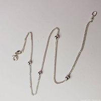 Full view of the silver anklet showing chain length, round bead details, and clasp attachment.