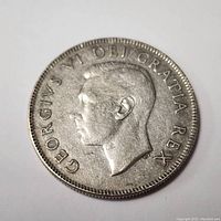 Obverse side of the coin featuring King George VI profile and inscription.