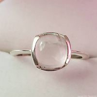 Front view of silver ring with rose quartz square cushion-shaped cabochon gemstone.