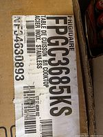 Label on original box showing model FPGC3685KS and stainless steel cooktop