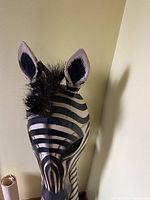 Close-up photo of the zebra head wall-mounted mask showing detailed black and white striping and black fur mane