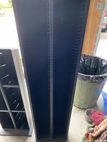 Two tall black CD towers with multiple slots each, empty, shown from front and top angles.