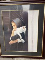 Front view of the first framed farm style print depicting a girl holding a white cat.