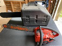 Side view of Homelite Super chainsaw with carrying case