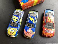 Three 1/24 scale Nascar diecast cars featuring SpongeBob SquarePants (#48), Patrick Star (#5), and Cheez-It (#25) liveries.