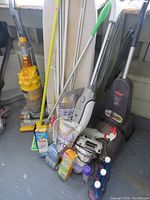 Group photo showing Dyson DC14 vacuum, Shark vacuum, Bissell vacuum and all included cleaning accessories and supplies.