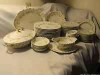 Full view of the Haviland Limoges dinnerware set showing plates, bowls, serving platters, and covered casserole dish assembled on display.