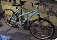 Right-side view of the blue Roadmaster Granite Peak mountain bike showing frame, handlebars, saddle, wheels, and drivetrain components.