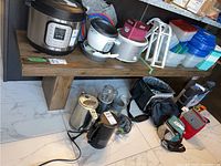 Front view of the bench under a countertop with kitchen appliances on top and marble-pattern floor tiles visible.