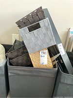 Woven and fabric bins stacked together showing various materials and sizes.