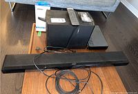 All components shown together: speaker array, control console, subwoofer, adapter box, remote, cables