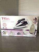 Box of T-fal Ultimate Autoclean 500 steam iron showing branding, model, and features.