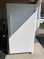 Front-facing view of closed freezer showing full exterior and handle