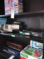 Sony Video 8 Pro CCD-V110 camcorder with two Sony video tapes and accessories on a shelf