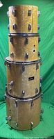 Stacked view of all four drums front-facing against green backdrop