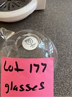Close-up of the Riekes Crisa brand sticker on the bottom of a glass item.