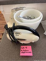Vintage Hamilton Beach blender with glass bowls and accessories on kitchen counter, showing overall condition and brand.