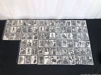 Full layout of 57 black and white photographic Avengers character cards arranged in plastic sleeves.