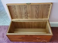 Cedar chest open with cedar wood interior paneling visible