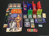 Overview of all items: consoles, cartridges, trading cards, books, boxes, tokens, discs