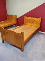 Side view of pine twin bed frame showing headboard, footboard, and slatted base