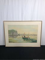 Full view of the framed serigraph print titled "Cod Jigging" depicting boats on calm water near cliffs.