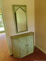 Entrance hall mirror mounted above corner cabinet, showing overall set and placement.